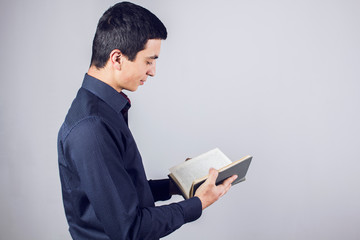 young man reads a book