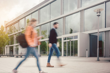 Blurred silhouette of students being busy on university campus