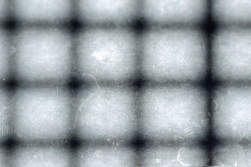 A shadow grid on the concrete floor, background texture