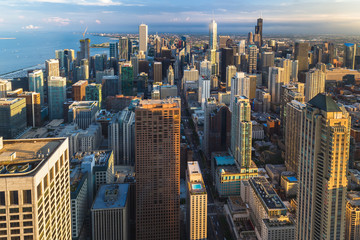 Chicago skyline panorama aerial view with skyscrapers over Lake Michigan with cloudy sky at dusk.