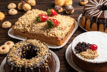 Various cakes on wooden background or table. Assortment of cakes for celebrations.