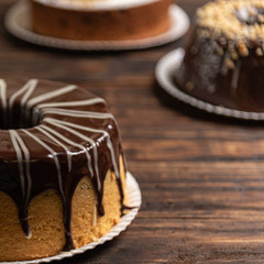 Various cakes on wooden background or table. Assortment of cakes for celebrations.
