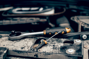 Car repair by a man in a workshop service station