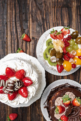 Various cakes on wooden background or table. Assortment of cakes for celebrations.