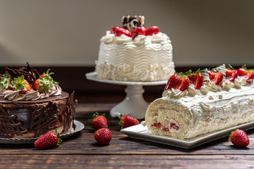 Various cakes on wooden background or table. Assortment of cakes for celebrations.