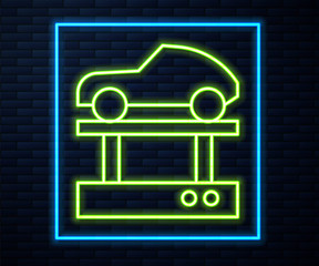 Glowing neon line Repair car on a lift icon isolated on brick wall background. Repair of the underbody, suspension, wheels and engine.  Vector Illustration