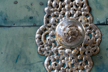 Decorative metallic handle on ironwork doors fittings, vintage light blue gate, azure color