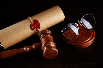 Last will and testament and glasses with wooden gavel.