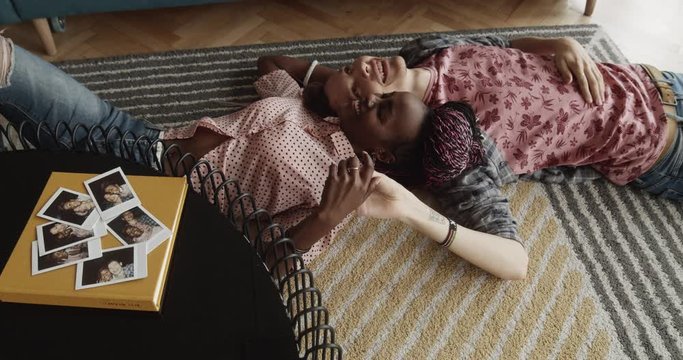 Couple Lies On The Floor At Home