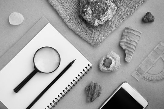 Geology rock laboratory. Stone samples, loop, notebook and mobile phome at geological laboratory. Laboratory for analysis of geological soil materials, stones, minerals, rocks samples for researchers