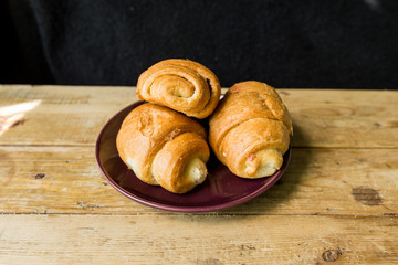 croissants on a burgundy plate