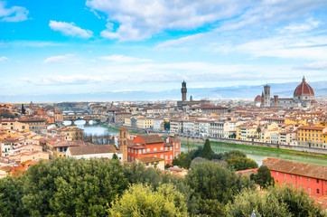 Obraz premium Amazing cityscape of Florence, Tuscany, Italy. Historical city center along Arno river with major sights Ponte Vecchio Bridge and Santa Maria Cathedral. Mountains in the background