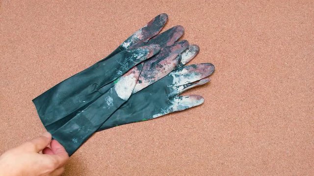 Safety Gloves being set over a cork surface