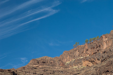 Fototapeta na wymiar Cliff and clouds in The Nublo Rural Park. Mogan. Gran Canaria. Canary Islands. Spain.
