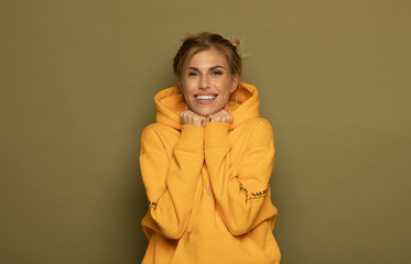Fototapeta premium Portrait of a pretty smiling woman posing isolated on a color background.