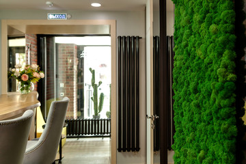 Decorative wall of green moss in a beauty salon
