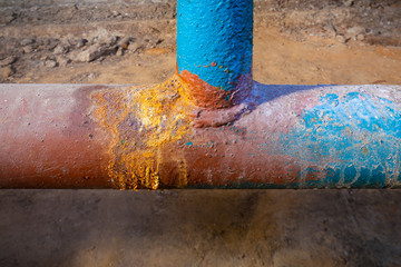 Basement apartment house. Old pipe - tee. Water supply pipe. Picture taken in Ukraine. Kiev region....