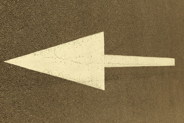 The pointing arrow on the asphalt is painted with white paint. Left traffic sign.
