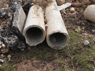 Old asbestos cement pipes on the construction site.