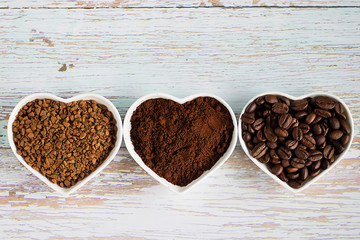Coffee beans, ground coffee and freeze-dried coffee. on wooden  background. Soft focus.