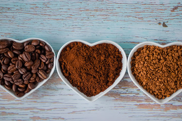 Three types of coffee: coffee grains, ground coffee and freeze-dried coffee. Soft focus.