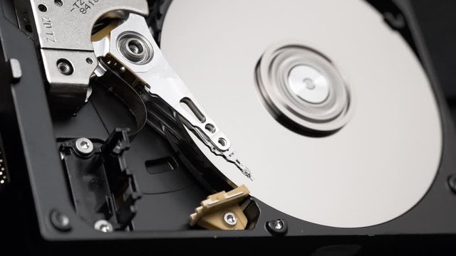 Macro, Close-Up of Actuator Arm of Computer Hard Disk Drive in Work. Slow Motion.