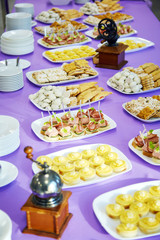 Banquet table with canapes and cookies
