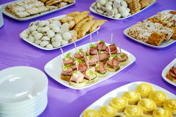 Banquet table with canapes and cookies