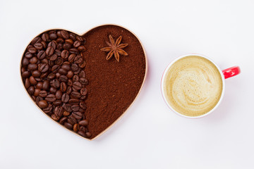 Decorative coffee heart and cup of cappuccino. Isolated on white background. Top view from above.
