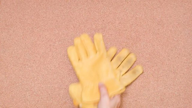 Security Gloves being tossed over a cork surface