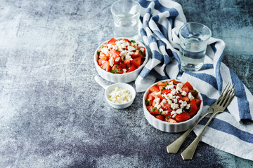 Feta cheese tomato salad in a white bowl