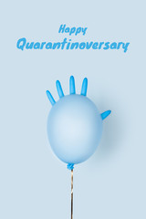 Anniversary celebrations during the quarantine period. Happy anniversary concept on self-isolation and social distancing. A festive ball made of medical glove on a blue background.