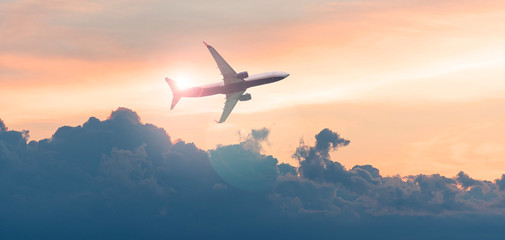 Commercial airplane, aircraft in the sky during sunset, evening sky and passenger plane