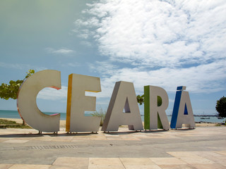 Tourism plate with inscription Ceara in large letters on the beachside in the city of Fortaleza,...