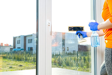 Obraz na płótnie Canvas Spring washing of a dirty window. service for washing windows in Domestic homes. a woman in blue gloves provides a window cleaning service. Cleaning service concept