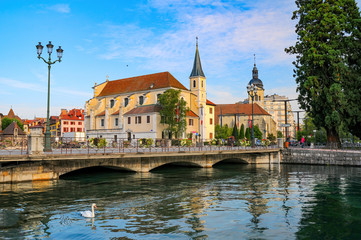 Church of Saint Francois de Sales in Annecy, France. White swan is swimming on Thiou river