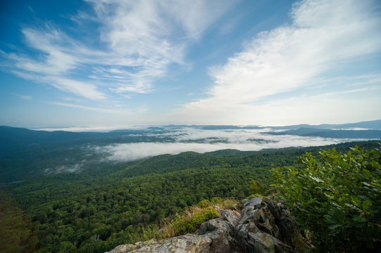 view of the valley from the height of the mountain range in fog © Вадим Лагутов