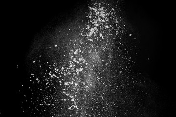 Wonderful pattern of white powder of light snow and flour explodes on black background