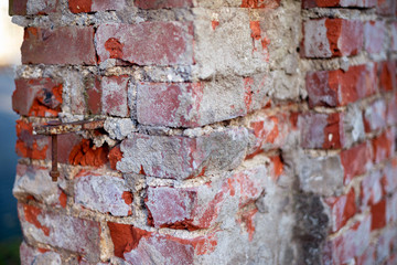 without care the brick is destroyed over time by the old brick fence. Abandoned brick fence, closeup brick fence, fence in need of repair