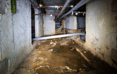 Basement of a residential building in the city. Pipeline with water and sewage. Color image. Photo-engraved in Ukraine, Kiev region.