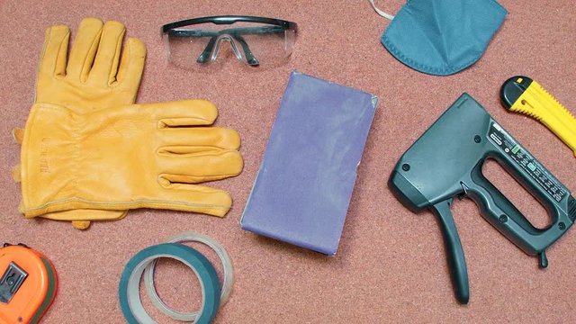 Set of tools and security equipment being removed from a cork surface