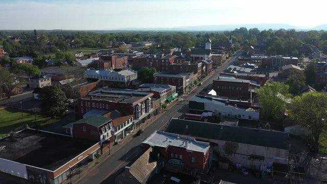 Camera flying east into the sun along the mainstream in Charles Town, West Virginia.