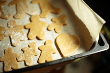 a little boy helps bake cookies