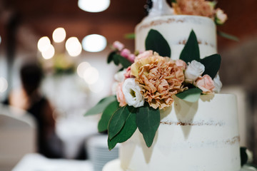 photo of a layered wedding cake with flowers