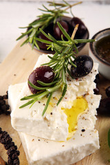 Greek cheese feta with rosemary and olives. Healthy ingredient for cooking salad. Chopped Goat feta cheese with gourmet herbs