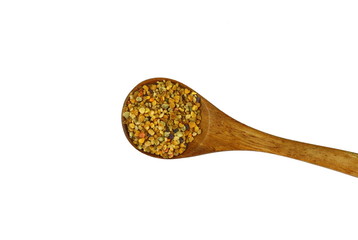 Pile of bee pollen in a wooden spoon isolated on white.