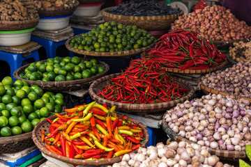 Baskets with fruits and vegetables, lime, pepper on the traditional  street market, Hanoi, Vietnam.