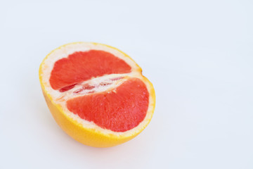 Naklejka na ściany i meble Half yellow red grapefruit on a white background.