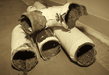 Fragments of an old pipe. Apartment in a multi-storey residential building in the city. Several...