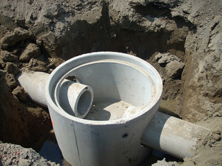 Precast concrete manhole with two pass through pipe connections